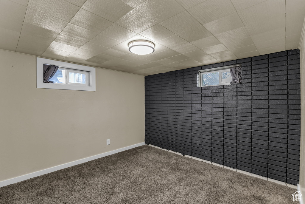 Basement featuring carpet, healthy amount of natural light, and baseboards