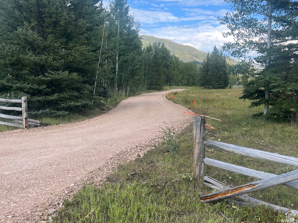 View of dirt / gravel road featuring a mountain view