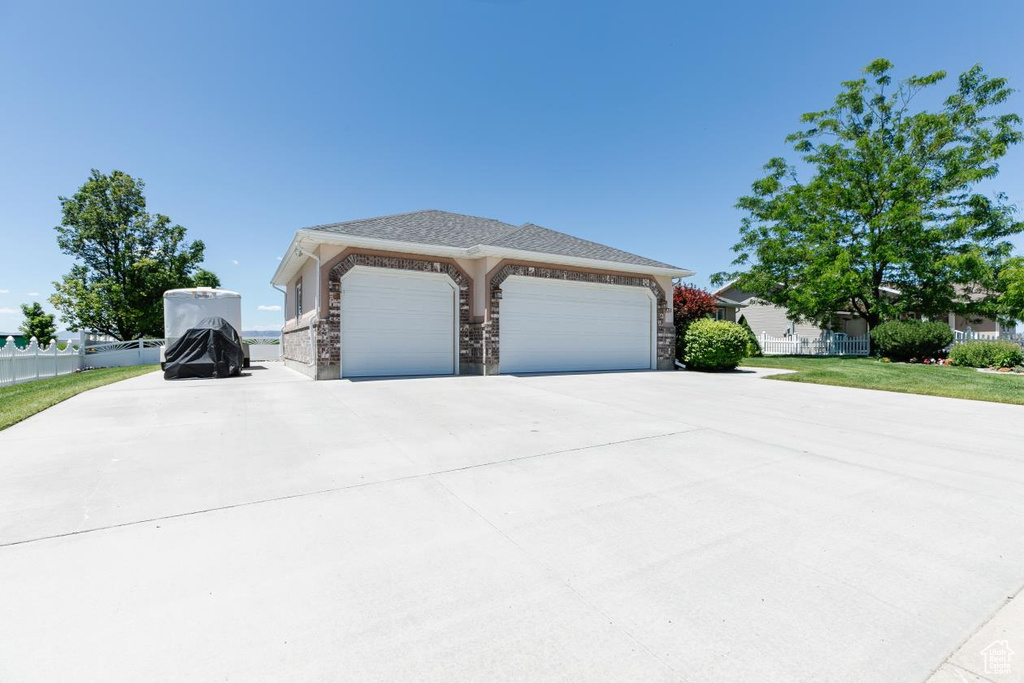 View of front facade featuring driveway and an attached garage