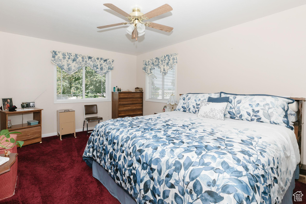 Bedroom featuring carpet flooring, baseboards, and a ceiling fan