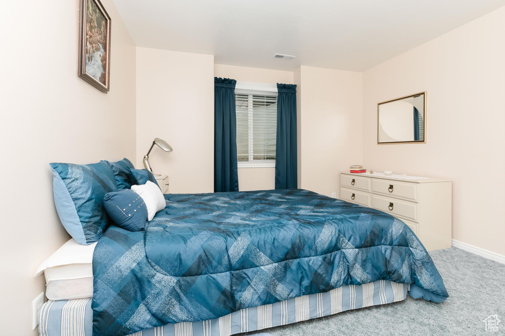Carpeted bedroom with baseboards