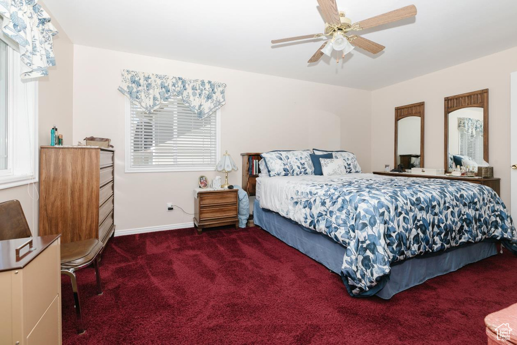 Bedroom featuring carpet flooring, baseboards, and ceiling fan