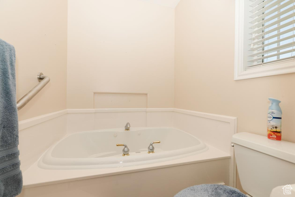 Full bathroom with a bath and toilet