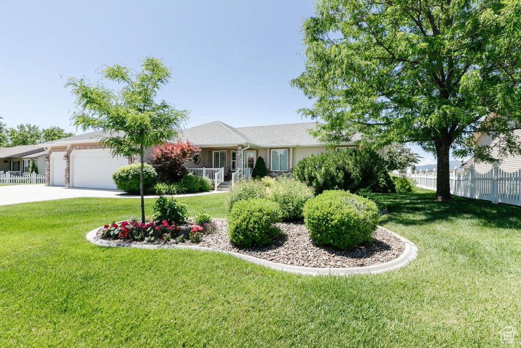 Single story home featuring an attached garage and driveway