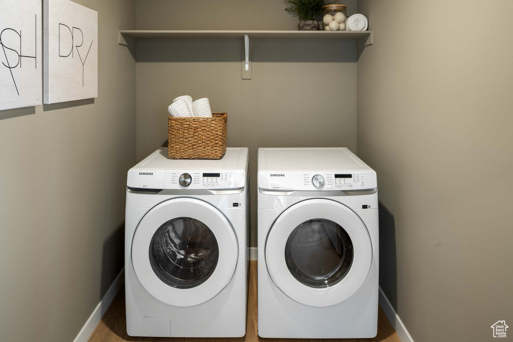 Washroom featuring washer and clothes dryer and baseboards