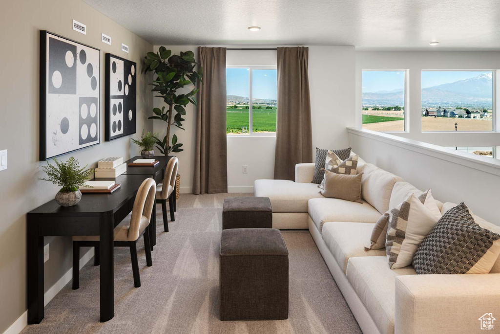 Carpeted living room with baseboards and a textured ceiling