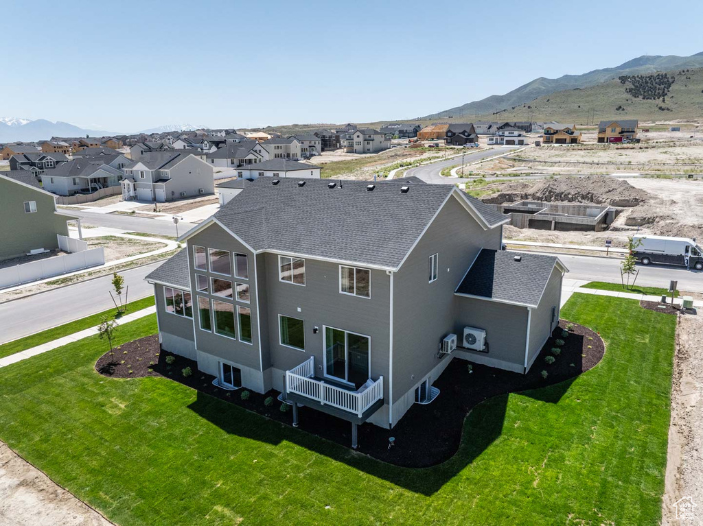 Aerial perspective of suburban area featuring a mountain backdrop