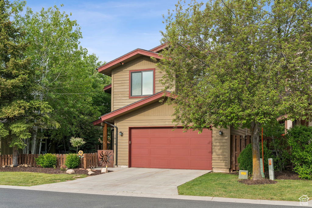 View of front of house with a garage and driveway