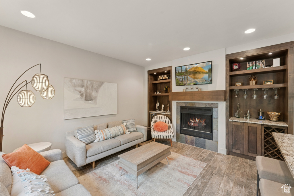 Living area featuring light wood-type flooring, a fireplace, and recessed lighting