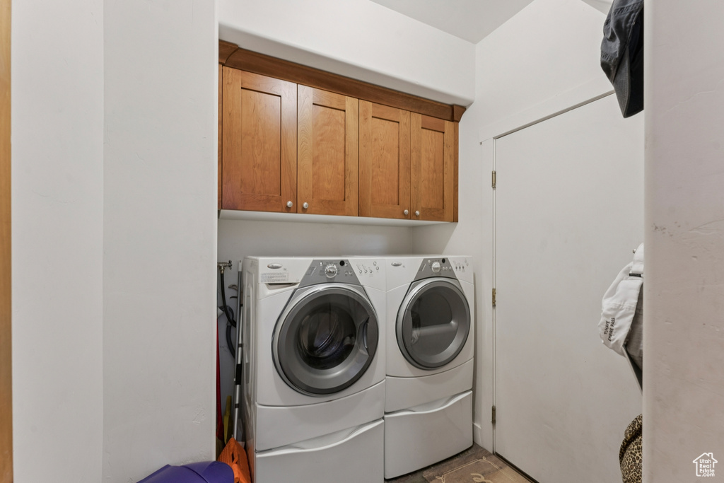 Laundry area with washer and clothes dryer and cabinet space