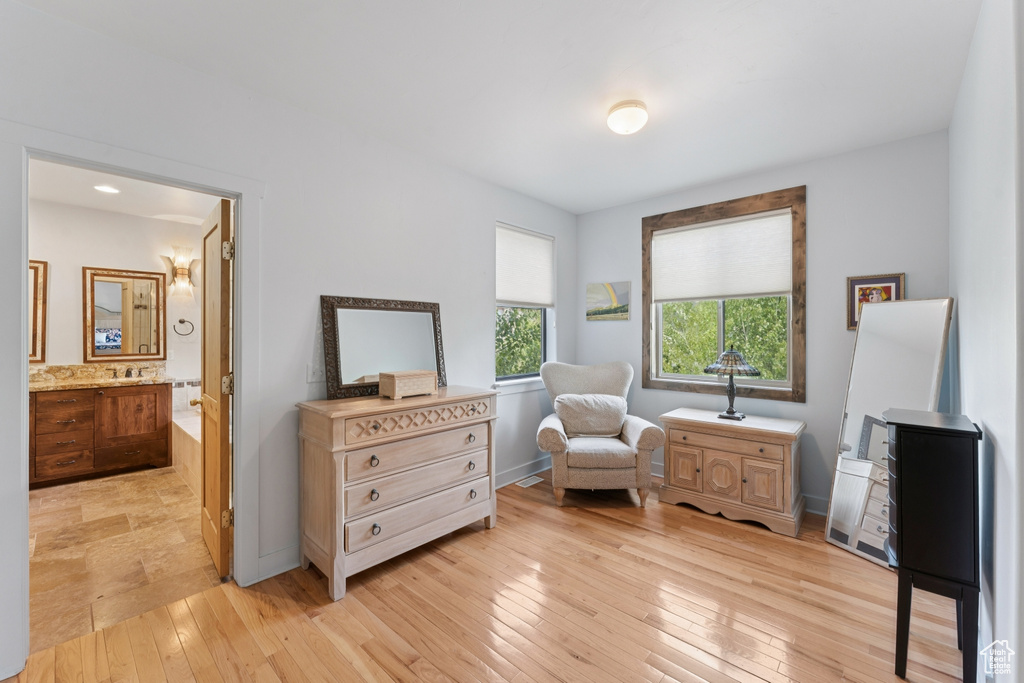 Sitting room featuring light wood-style flooring and baseboards