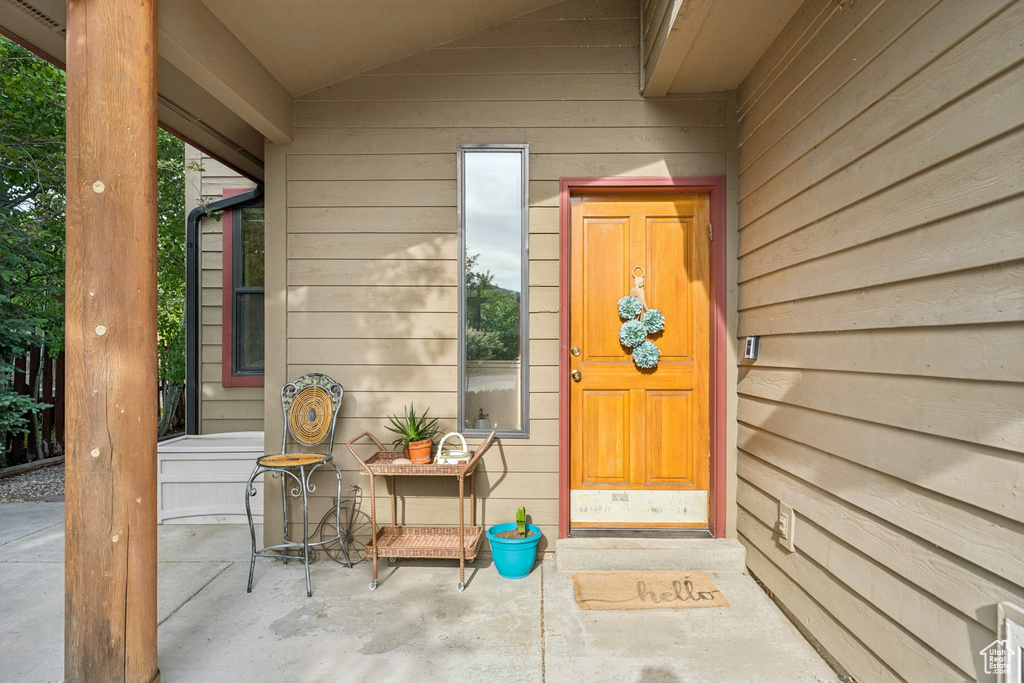 Doorway to property featuring a patio area