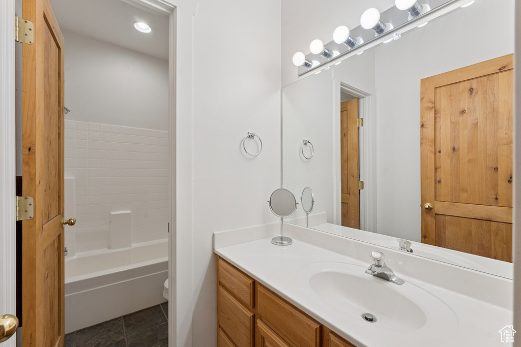 Full bathroom featuring vanity, toilet, and tile patterned flooring