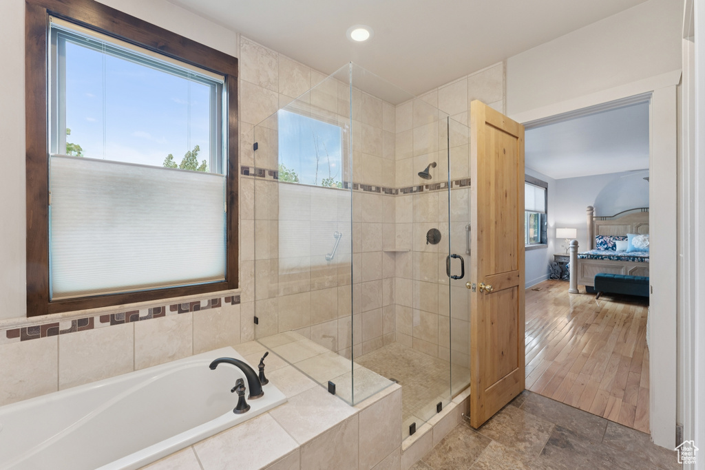 Ensuite bathroom featuring a garden tub, a stall shower, and recessed lighting