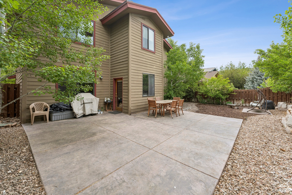 Fenced backyard with a patio and outdoor dining area