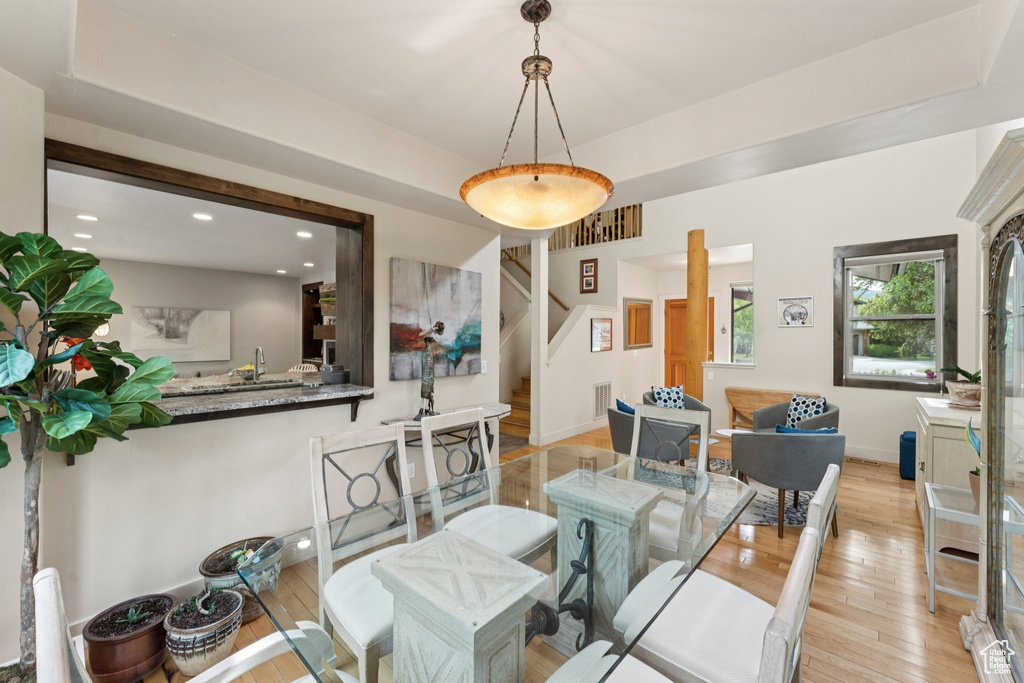 Dining space with light wood-style flooring, stairway, recessed lighting, and baseboards