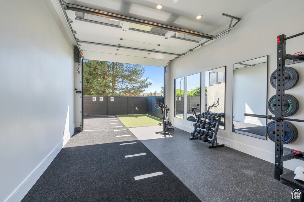 Garage featuring baseboards and recessed lighting
