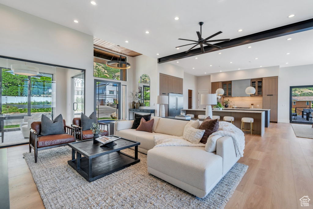 Living area featuring recessed lighting, light wood-style floors, and a ceiling fan