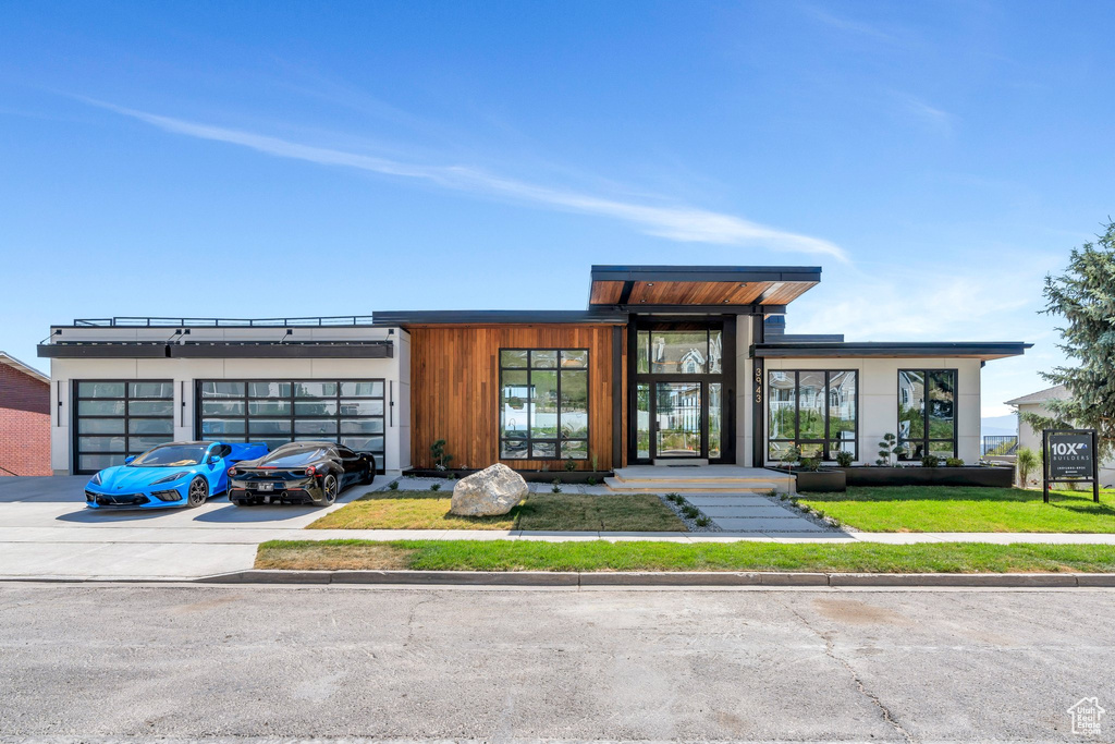 View of building exterior featuring a garage and concrete driveway