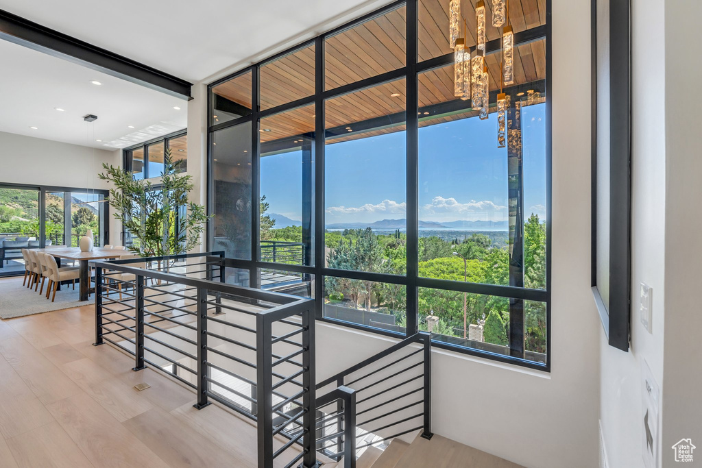 Staircase featuring wood finished floors, a chandelier, and recessed lighting