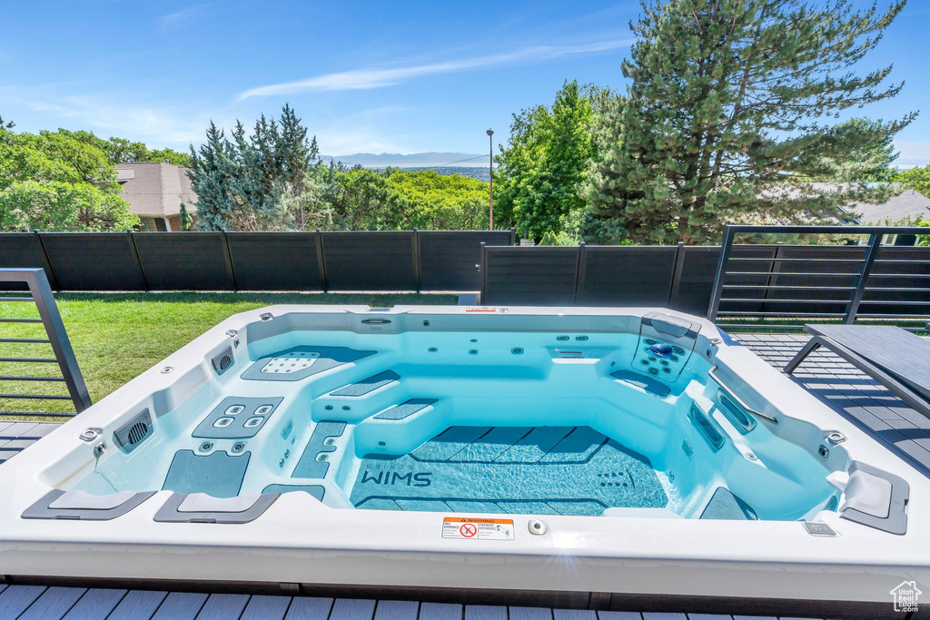 View of swimming pool featuring an outdoor hot tub and a mountain view