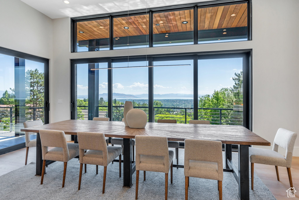 Dining space with light wood finished floors and recessed lighting