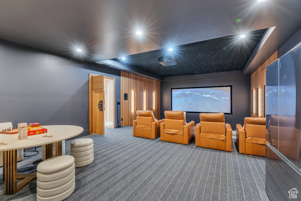 Home theater featuring carpet, recessed lighting, and a tray ceiling