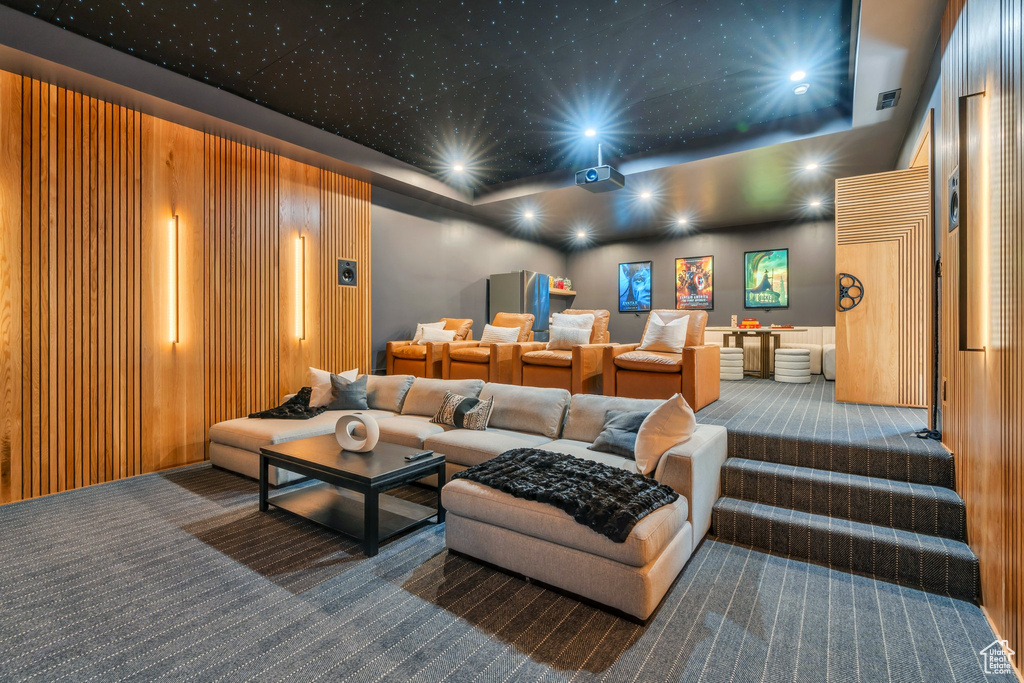 Home theater with carpet flooring, a tray ceiling, and recessed lighting