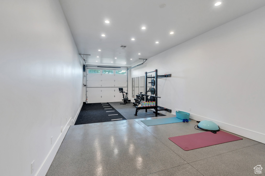 Workout room featuring a garage, recessed lighting, and baseboards