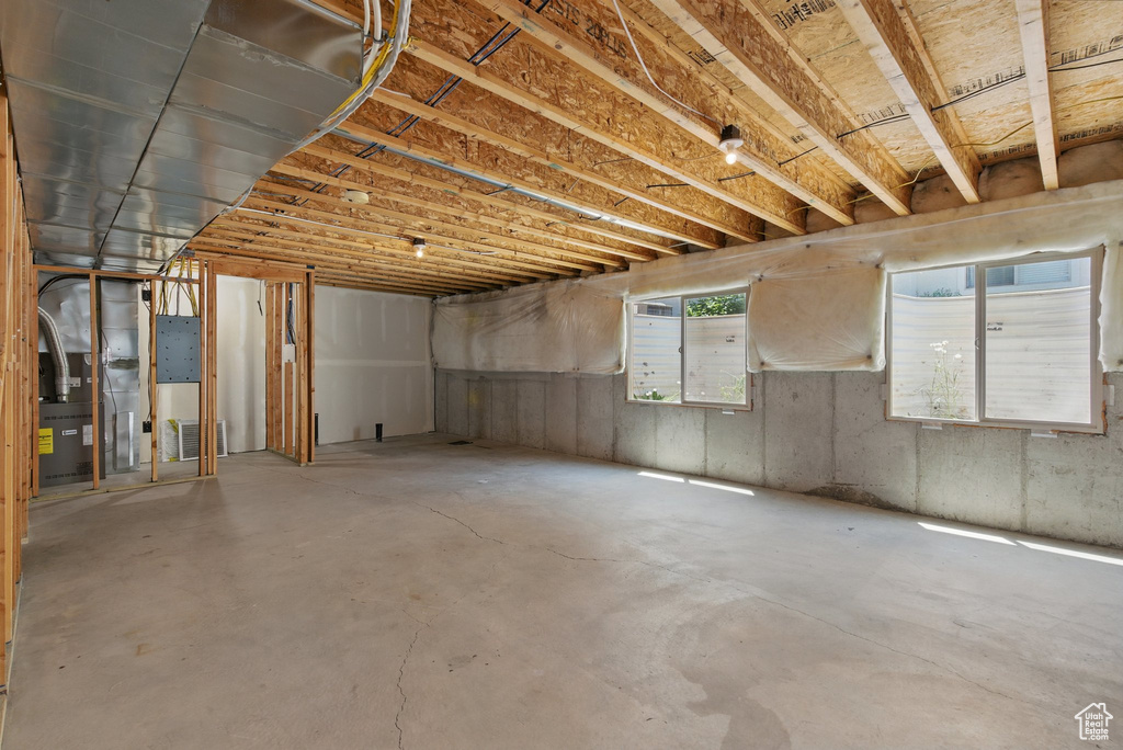 Basement featuring heating unit