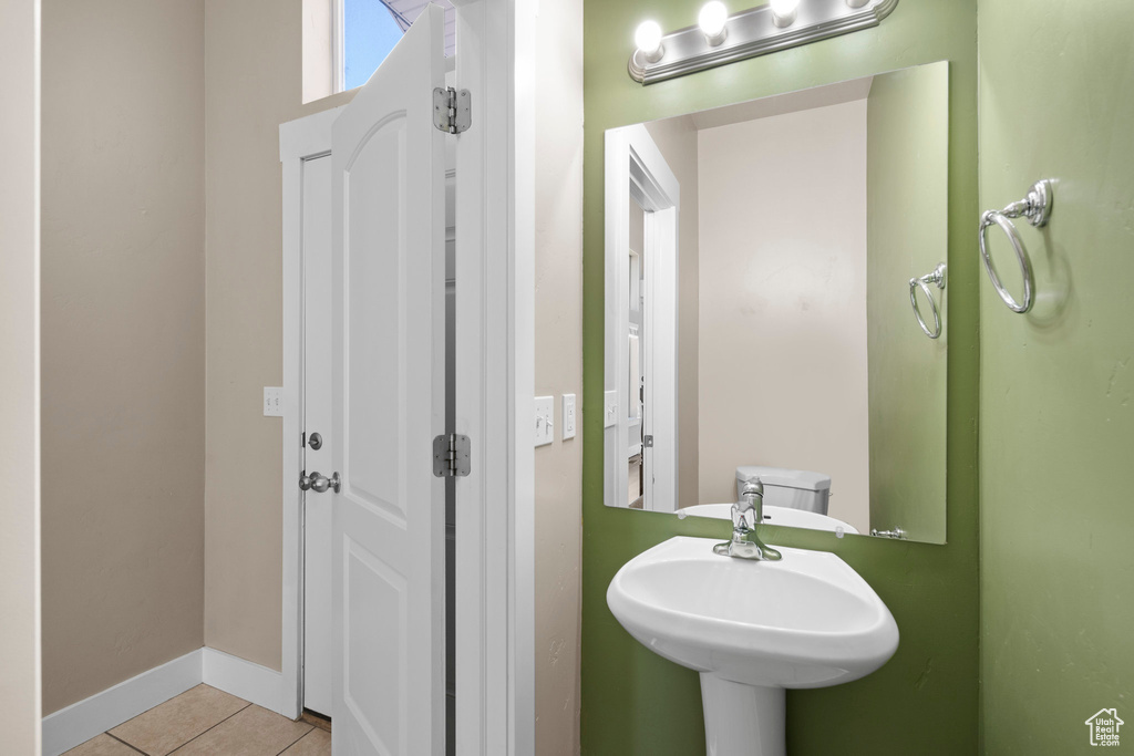 Bathroom featuring tile patterned flooring and baseboards