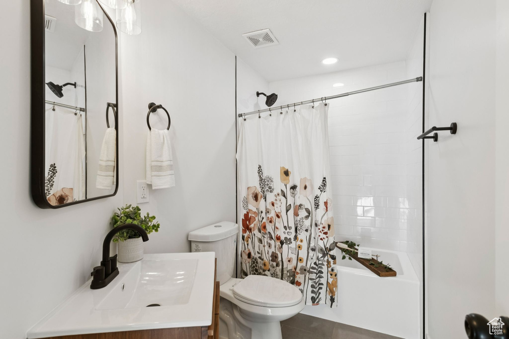 Bathroom with toilet, vanity, shower / bath combo, and tile patterned flooring