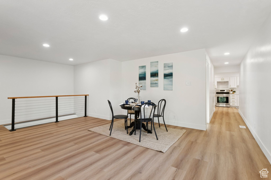 Dining space featuring light wood-type flooring, recessed lighting, and baseboards