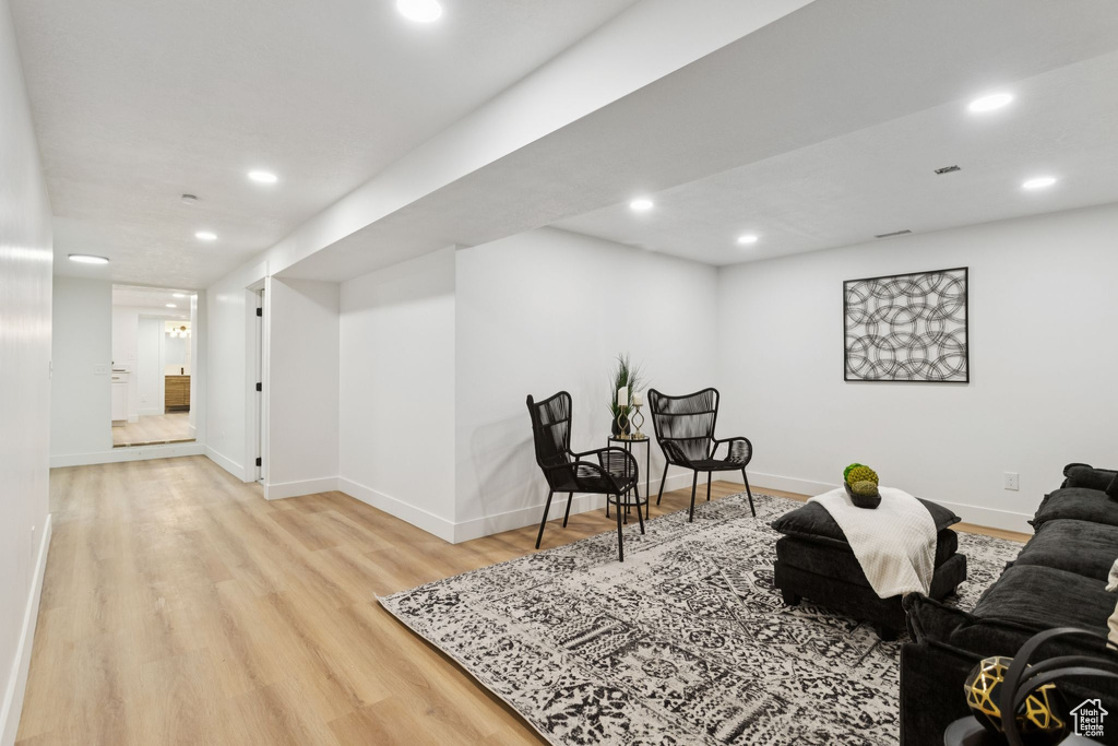Living room featuring wood finished floors, recessed lighting, and baseboards