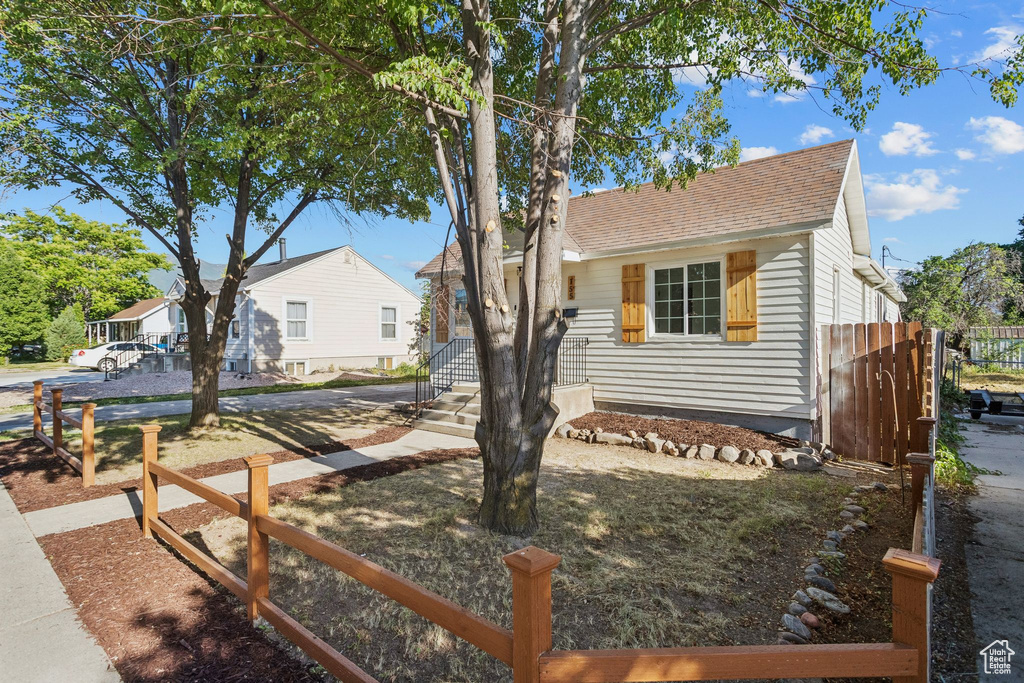 View of front of home with roof with shingles