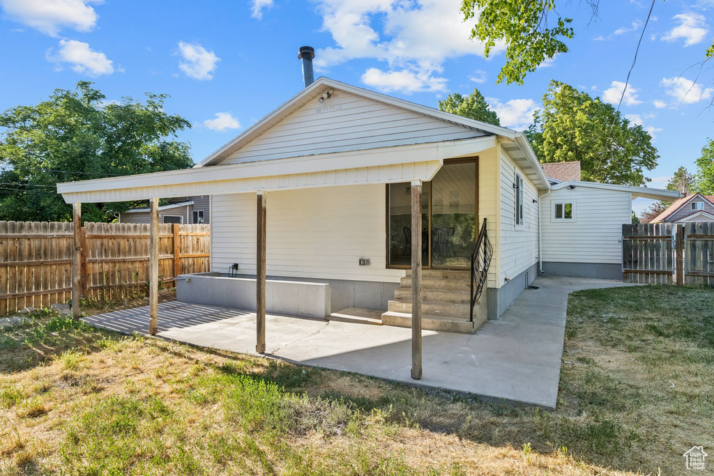 Rear view of property featuring a patio
