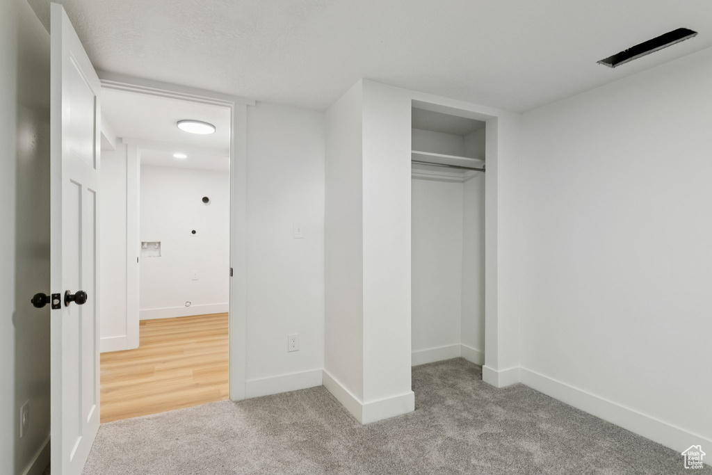 Unfurnished bedroom with carpet, baseboards, and a closet