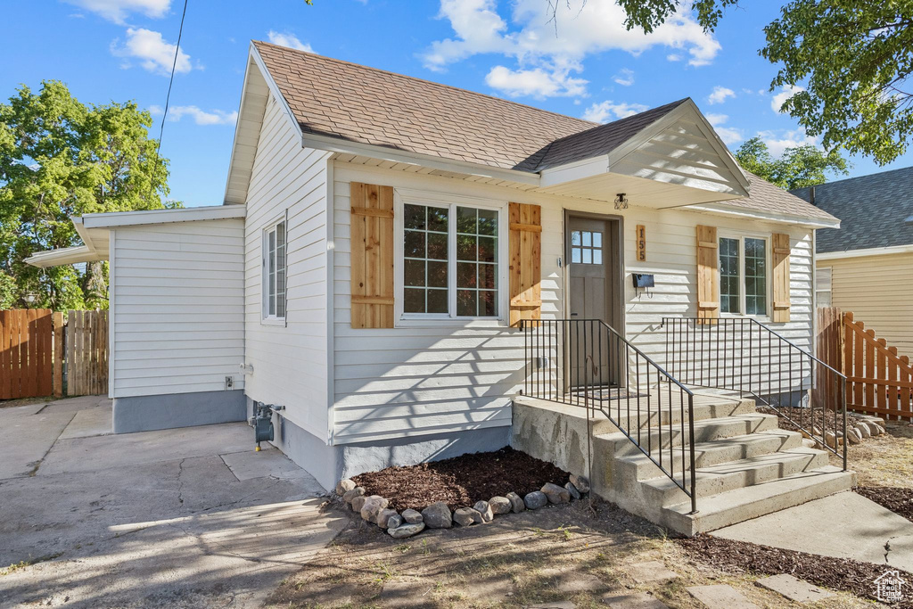View of front of home with roof with shingles