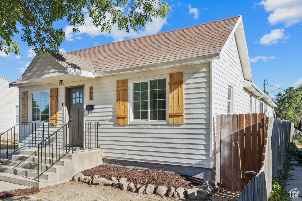 Bungalow-style home with roof with shingles