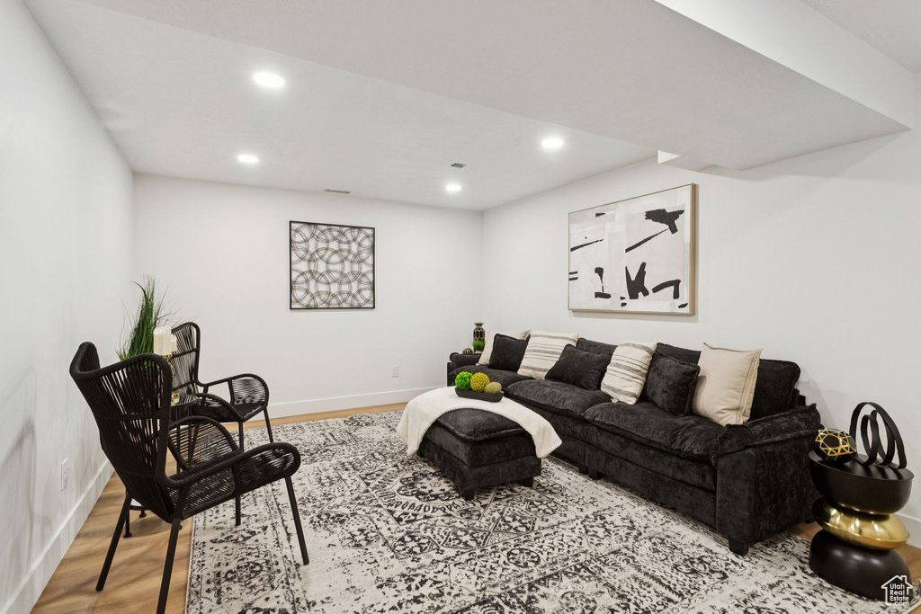 Living area with wood finished floors, recessed lighting, and baseboards