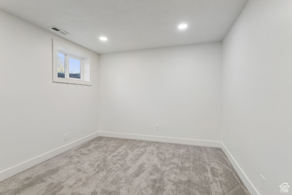 Below grade area featuring carpet flooring, baseboards, and recessed lighting