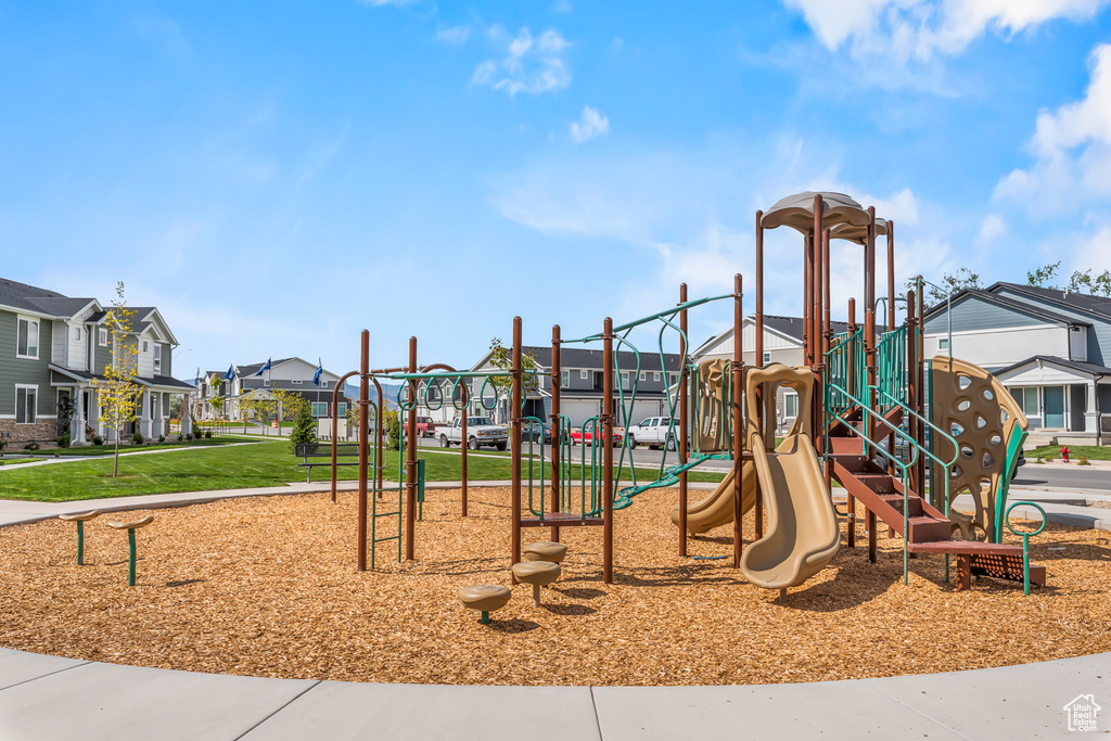 Community play area featuring a residential view and a yard
