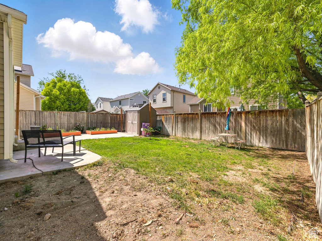 View of yard with a patio and a residential view