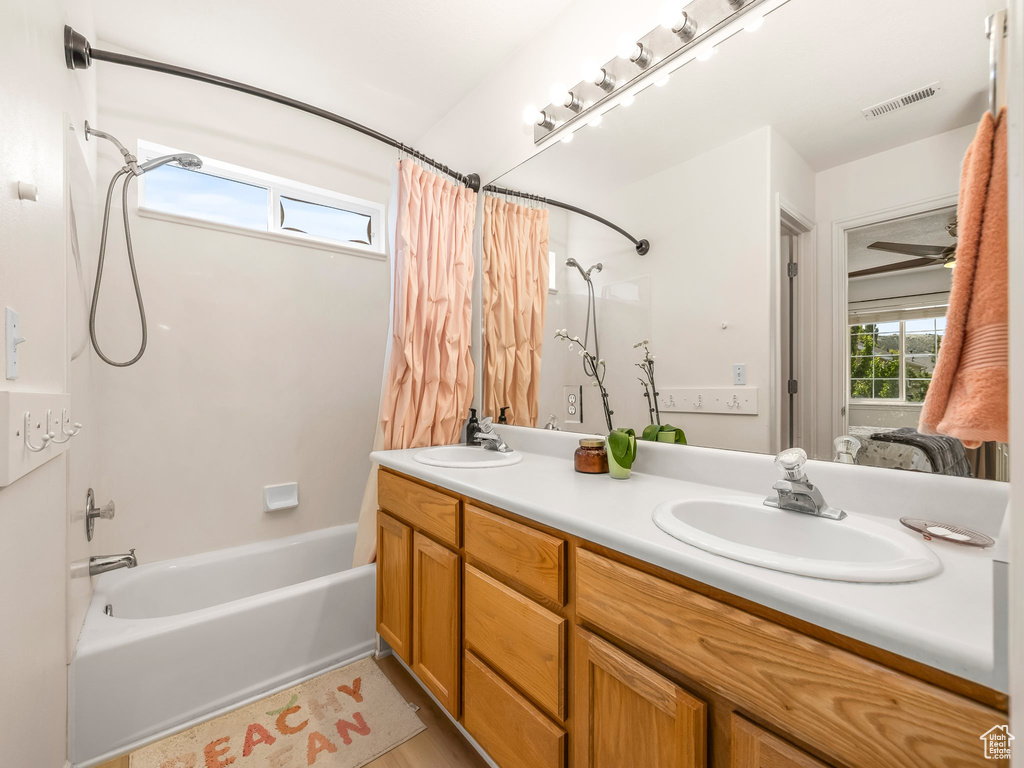 Bathroom with shower / tub combo and double vanity