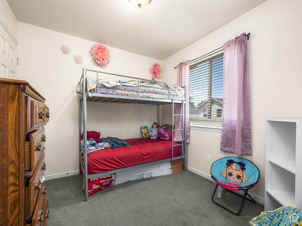 Bedroom featuring carpet floors and baseboards