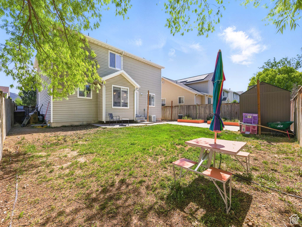 Back of house with a patio