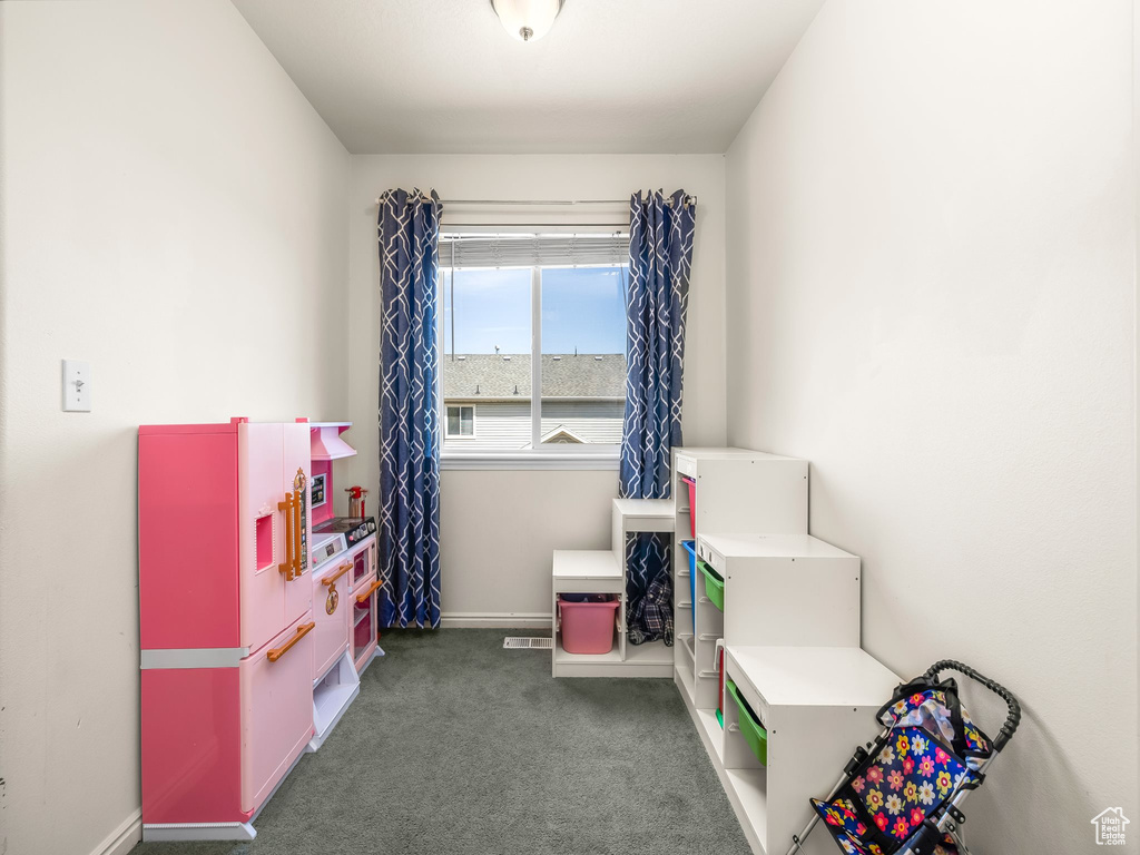 Recreation room featuring carpet and baseboards
