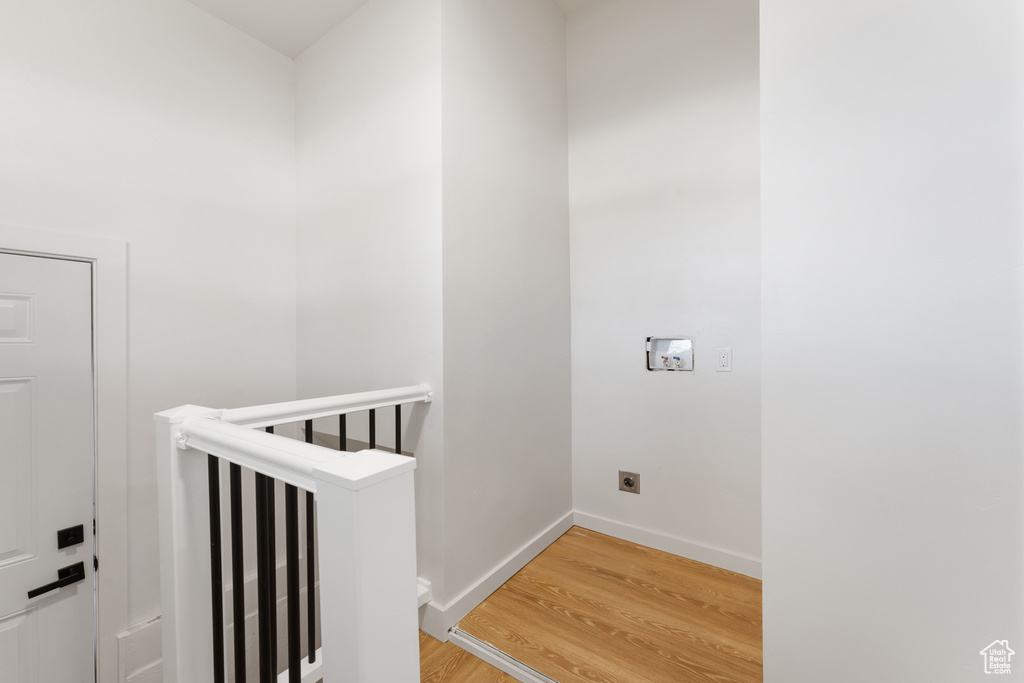 Staircase featuring wood finished floors and baseboards