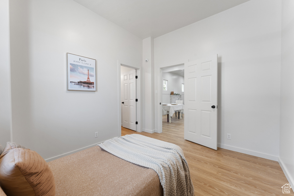 Bedroom with light wood-type flooring and baseboards