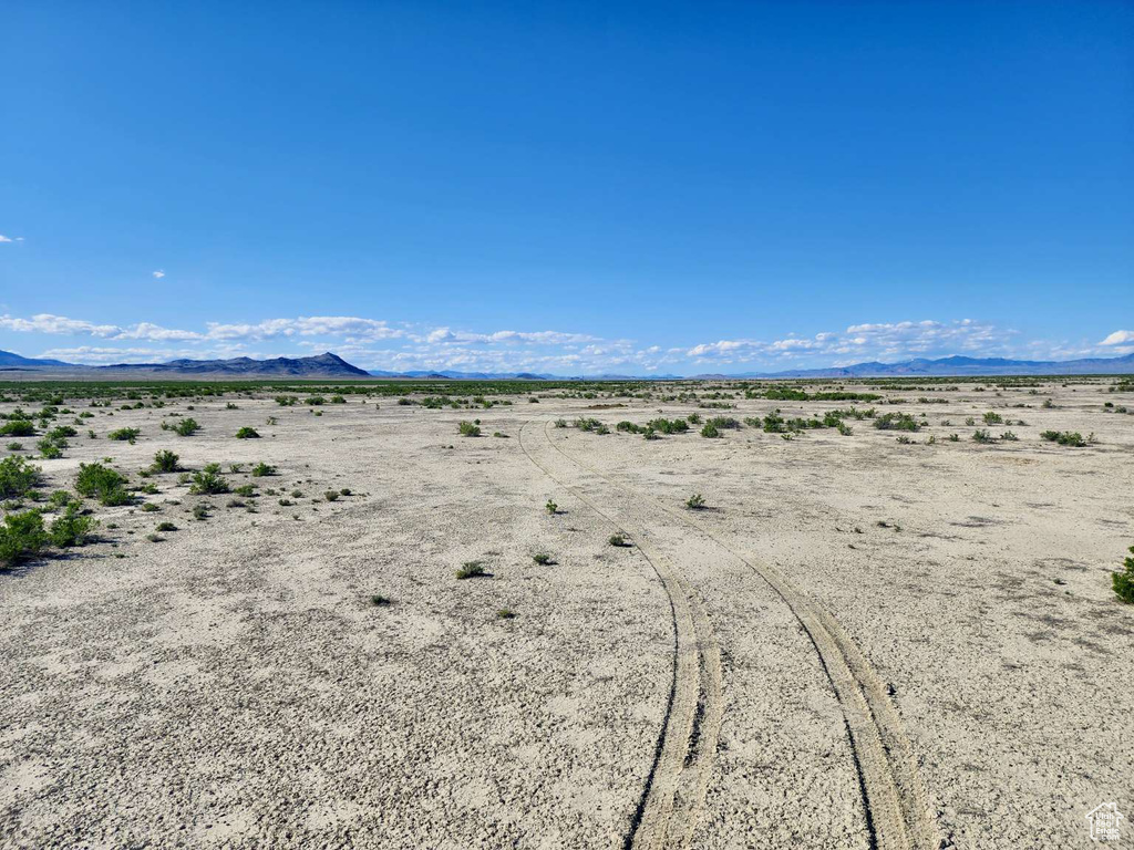 View of mountain backdrop with a desert landscape and rural landscape